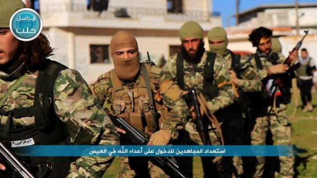 Nusra Front fighters marching toward the village of al-Ais in Aleppo, Syria, in April.