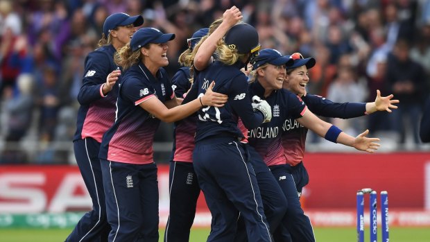 The England team celebrates after taking India's final wicket on Sunday.