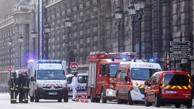 Rescue vans park outside the Louvre in Paris on Friday.