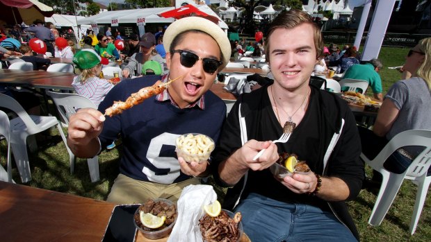 Michael Huynh and Luke Spiteri enjoy the food at the 2015 Paniyiri Festival at Musgrave Park.