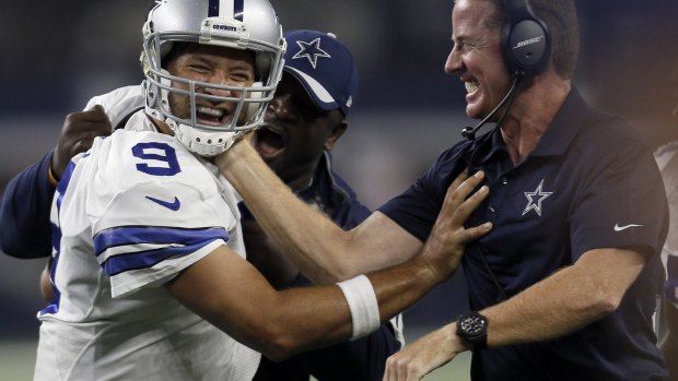 Celebrate good times: Dallas Cowboys quarterback Tony Romo and head coach Jason Garrett.