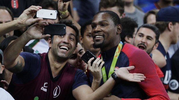 Smile: Kevin Durant takes selfies with fans after winning the men's basketball gold medal.