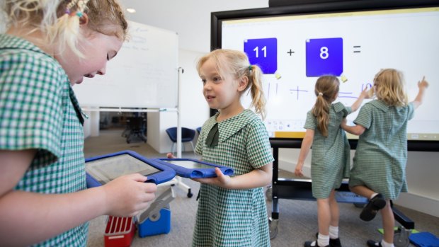 Kindergarden students from Camdenville Public School use some of the technology of the classroom of the future at a media event in Eveleigh. L-R are Isla  Bridges-Dodd, Sian Gill, Matilda Harris, and Charlize Dunn.