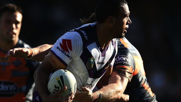 Storm centre Will Chambers is tackled during the come-from-behind win against Wests Tigers last Sunday.