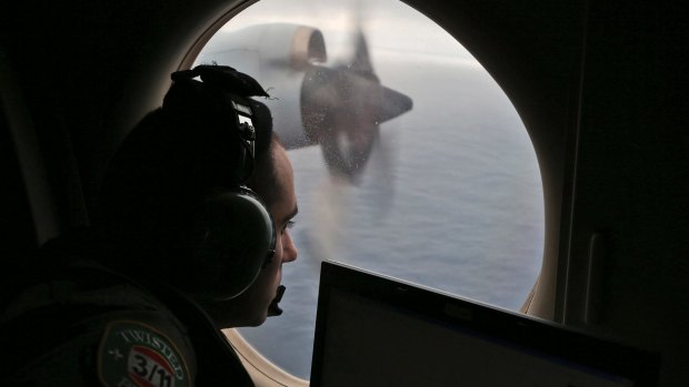 Flight officer Rayan Gharazeddine scans the water in the southern Indian Ocean off Australia from a Royal Australian Air Force AP-3C Orion during a search in 2014.