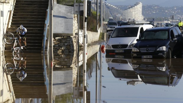 A man tries to make his way after floods hit Biot, near Cannes.