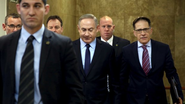 Israeli Prime Minister Benjamin Netanyahu, centre, arrives for a weekly cabinet meeting, in Jerusalem, on New Year's Day.