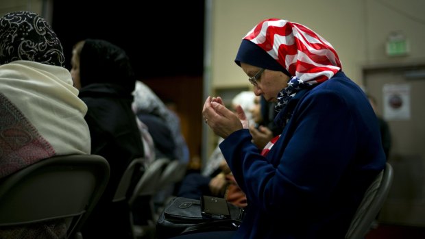 Jeelanne Gouda, of Rancho Cucamonga, California, prays during a vigil for the victims of the San Bernardino massacre at the Chino Valley Islamic Center.