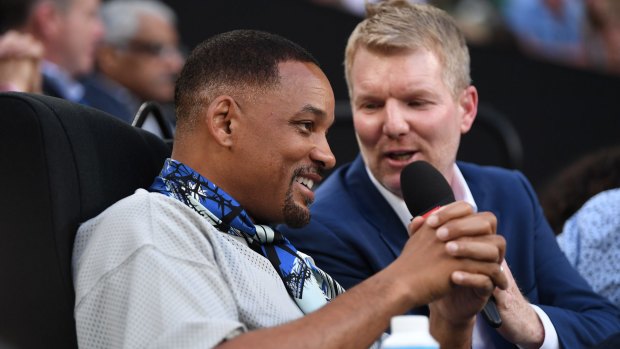 Calling time? Commentator Jim Courier interviews actor Will Smith at the  Australian Open. 