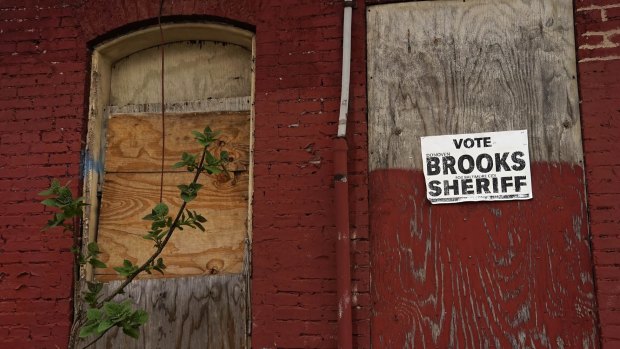 An election poster on a boarded-up house in Hollins Market, Baltimore.