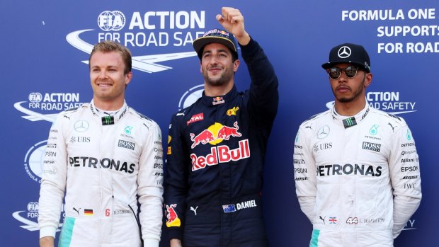 Ricciardo celebrates his pole position, beside Nico Rosberg, left, and Lewis Hamilton.