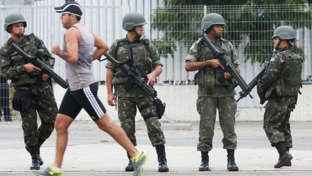 Brazilian soldiers stand on patrol during a security rehearsal of the Rio 2016 Olympic Games opening ceremony outside Maracana stadium last week.