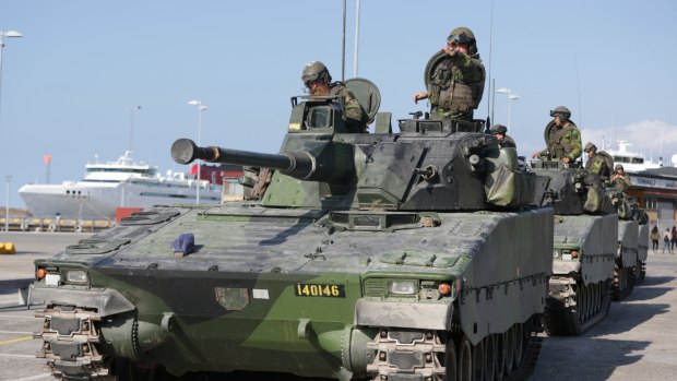 Swedish armoured personnel carriers in Visby harbour on the island of Gotland, Sweden.