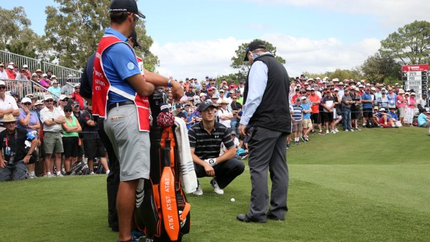 Argument: Jordan Spieth talks with a rules official after his ball was trodden on at the Australian Open.
