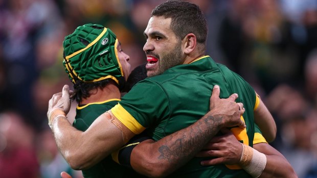 Feeling good: Greg Inglis celebrates another try against the Kiwis with teammate Johnathan Thurston on Saturday night.