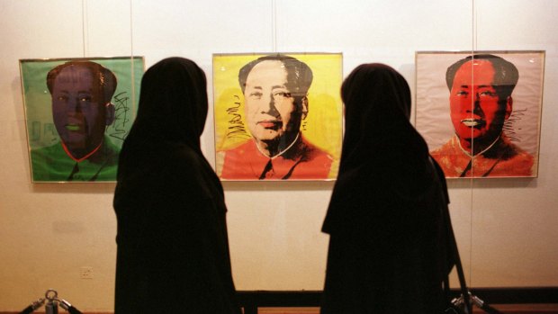 Growing relationship: Visitors to the Tehran Museum of Contemporary Art view Andy Warhol’s Chairman Mao artworks in 1999.