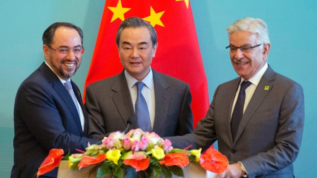 From left, Afghanistan Foreign Minister Salahuddin Rabbani, Chinese Foreign Minister Wang Yi and Pakistani Foreign Minister Khawaja Asif at their first dialogue meeting held in Beijing on December 26.
