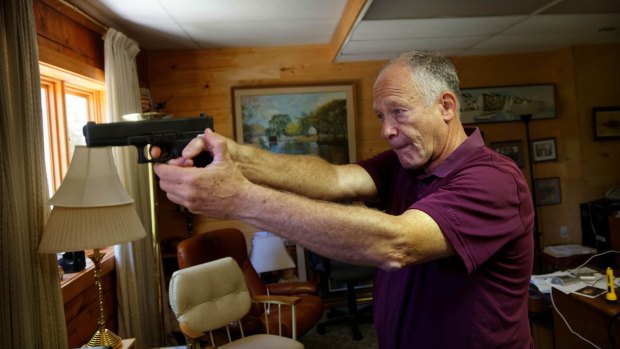 Richard Feldman with a Glock .45 calibre pistol, one of more than 100 guns he owns.