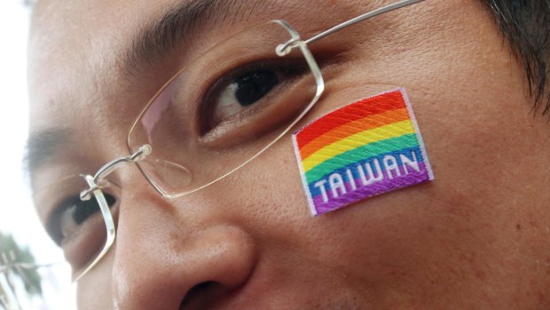 A participant wears a sticker on his cheek during a gay and lesbian parade in Taipei, Taiwan.
