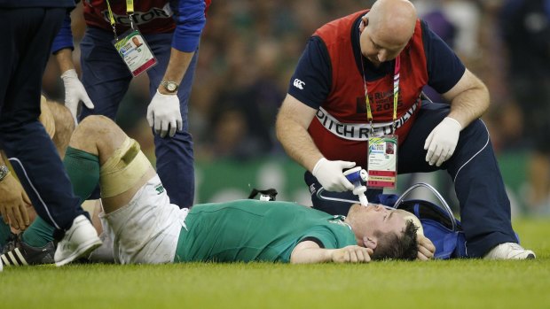 Ireland's Peter O'Mahony receives treatment for a knee ligament injury during the final pool game against France.