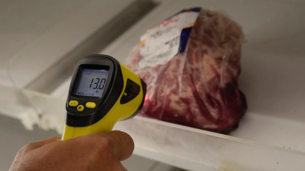 A council inspector checks a piece of meat at a supermarket in Rio de Janeiro on Monday.