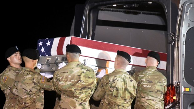 An Army carry team moves a transfer case containing the remains of Staff Sargeant Aaron Butler who died last week of injuries sustained from an improvised explosive device while conducting combat operations in Afghanistan.