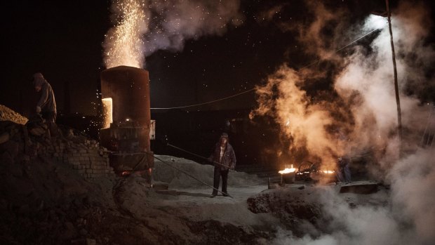 Chinese labourers work at an unauthorised steel factory in Inner Mongolia, China. 