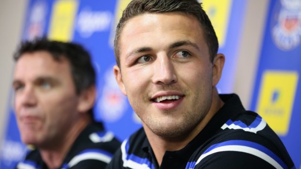 All smiles: Sam Burgess addresses the media with new boss Mike Ford.