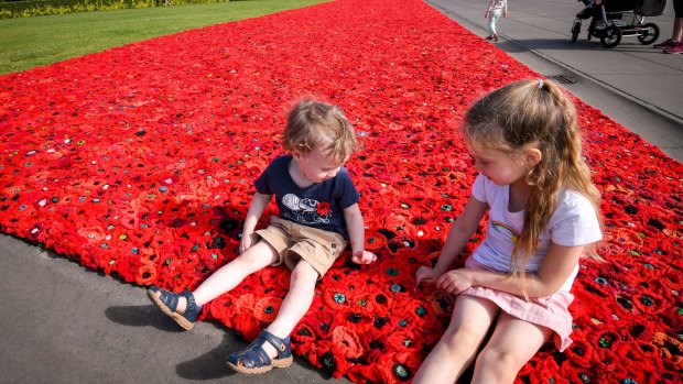Zoe, 5, and brother Gordon, 3 on the carpet of poppies at the Shrine.