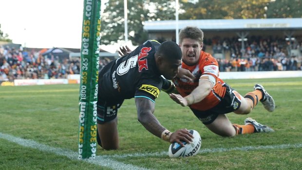 Iconic: Chris Lawrence unable to stop Kevin Naiqama at Leichhardt Oval last season.