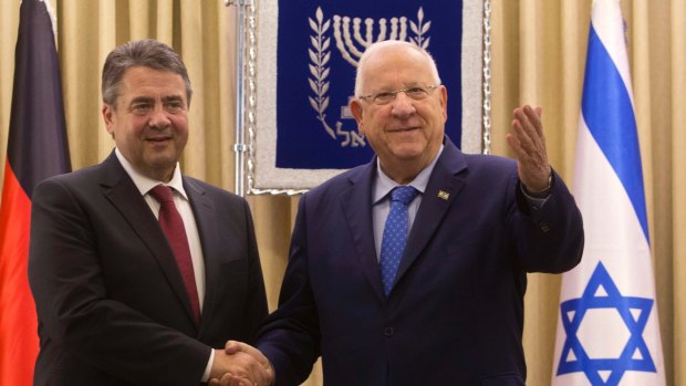 German Foreign Minister Sigmar Gabriel, left, shakes hands with Israeli President Reuven Rivlin in Jerusalem on Tuesday.
