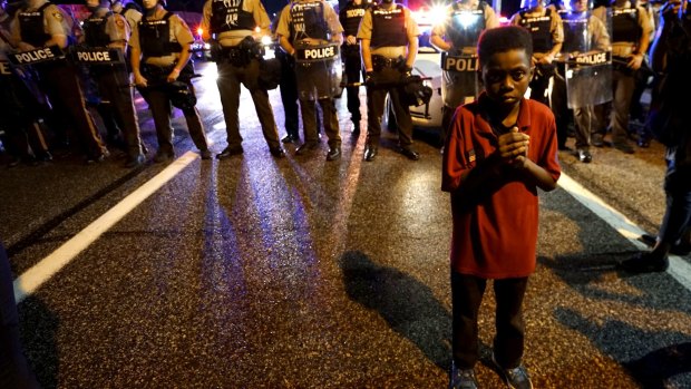 Eleven-year-old Amarion Allen stands in front of a police line shortly before shots were fired.