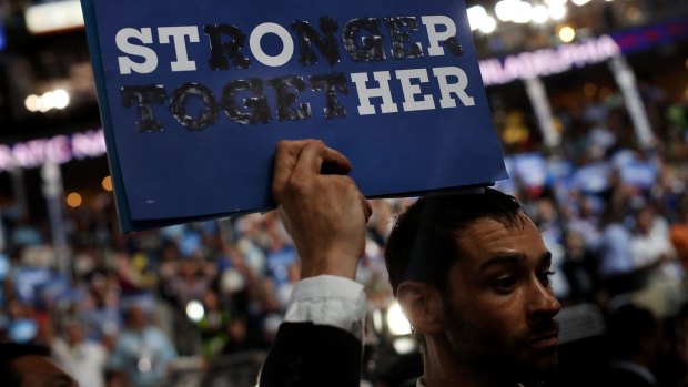 A delegate holds a sign altered to read "Stop Her" during the Democratic convention in Philadelphia.