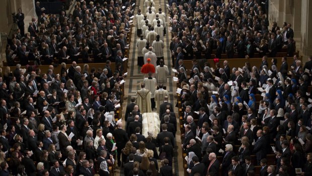The coffin of Supreme Court judge Antonin Scalia is carried through the Basilica of the National Shrine of the Immaculate Conception in Washington during his funeral Mass on Saturday, the same day Harper Lee was laid to rest.