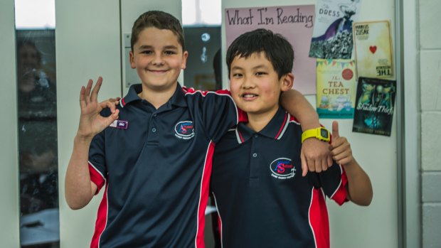 Amaroo School student Ross Kelly (left), who learnt sign language to talk with deaf friend Isam Gurung.