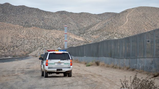 A US Border Patrol agent patrols a section of the US-Mexico border next to Ciudad Juarez. 