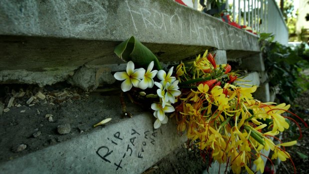 Messages and flowers mark the location at the rear of Turanga tower on Phillip St, Redfern, where Thomas Hickey died. 