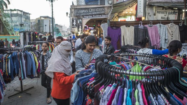 Customers browse clothes on display at a street market stall in Lucknow, Uttar Pradesh. The success of the ruling party's infrastructure projects has allowed it to hijack Narendra Modi's mantra of development.