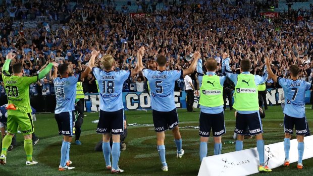 Sydney FC players celebrate with fans after the round one A-League match against the Western Sydney Wanderers.