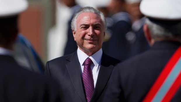 Brazil's President Michel Temer smiles as he receives military honors during a ceremony in Brasilia on Friday.