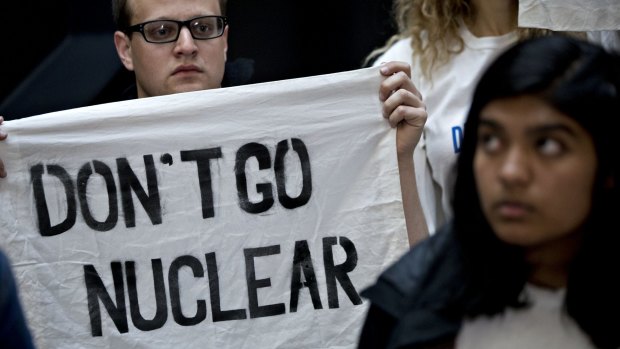 A demonstrator holds a "Don't Go Nuclear" sign on Capitol Hill in Washington, DC. 
