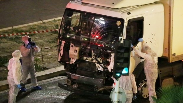 Authorities investigate a truck after it ploughed through Bastille Day revellers in the French resort city of Nice on Thursday.