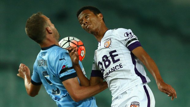Tete a tete: Matthew Jurman of Sydney FC and Jamal Reiners of the Glory compete for the ball.