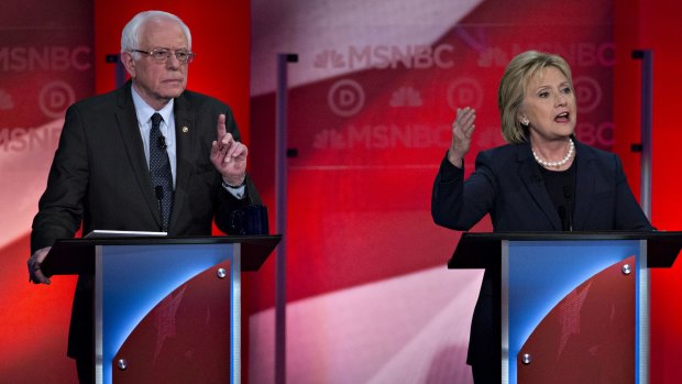 Hillary Clinton speaks as Bernie Sanders tries to interrupt at Thursday night's debate.