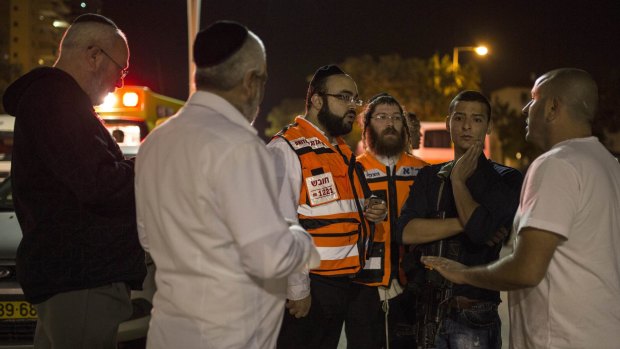 Israelis gather at the scene of the attack in Kiryat Gat, Israel, on Saturday.