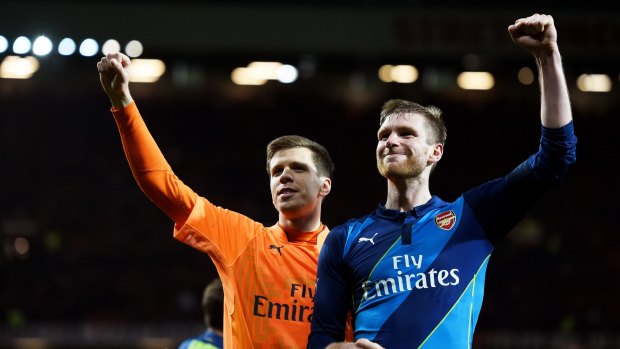 Wojciech Szczesny and Per Mertesacker of Arsenal celebrate following their team's 2-1 victory.