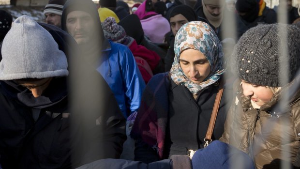 Migrants wait to be allowed to cross the border from Slovenia to Austria on Wednesday. Austria has put a cap on the number of refugees it wants to accept – 37,500 this year and a total of 127,500 through 2019.