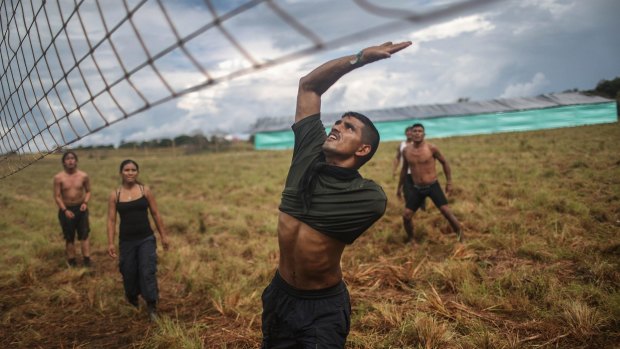 FARC rebel David, who lost his arm following wounds suffered in a firefight, plays volleyball in the Yari plains.