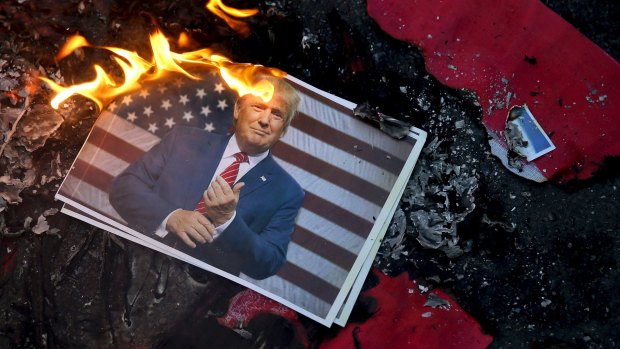 A portrait of Donald Trump is set on fire by Iranian protesting his decision to recognise Jerusalem as capital of Israel. 