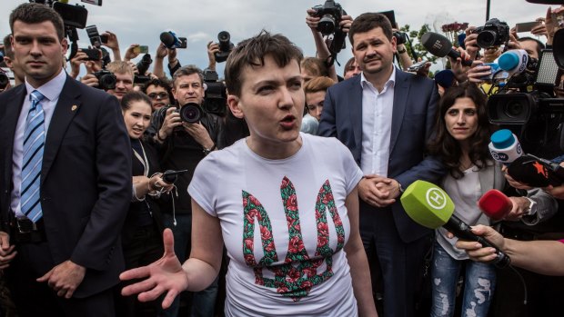 Freed Ukrainian military pilot Nadiya Savchenko is surrounded by media on her arrival at  Boryspil Airport in Ukraine. 